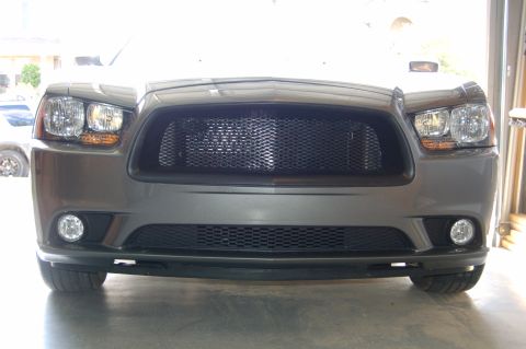 2012 Dodge Charger - Front view of a gray Dodge Charger, showing its grille and headlights.