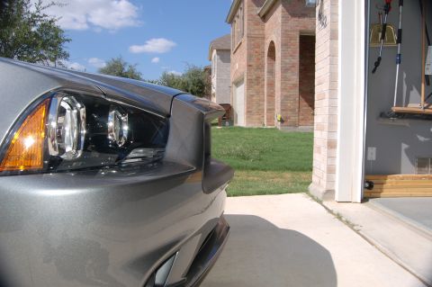 2012 Dodge Charger - Front corner view of a gray sedan, likely a 2011 model, parked in a driveway.