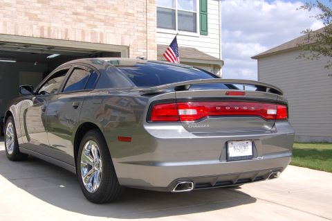 2012 Dodge Charger - Rear view of a gray Dodge Charger with a spoiler and chrome wheels.