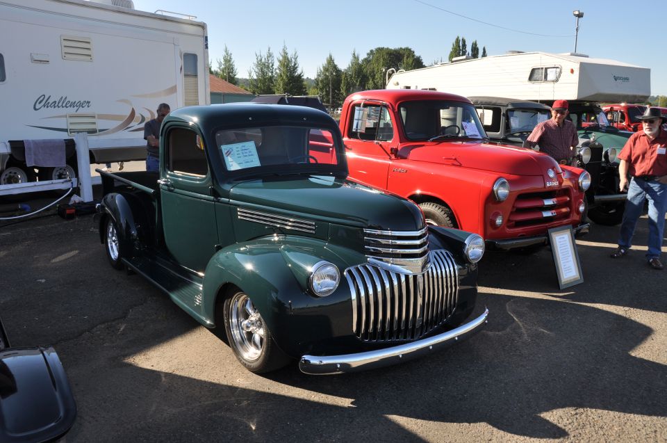 Green pickup truck with chrome grille and custom wheels