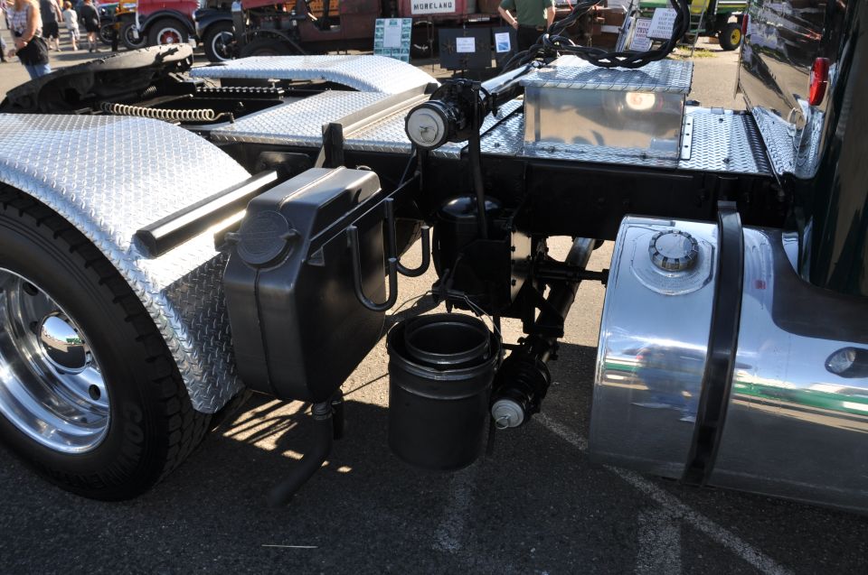 Close-up of a truck's rear suspension, fuel tank, and exhaust pipe