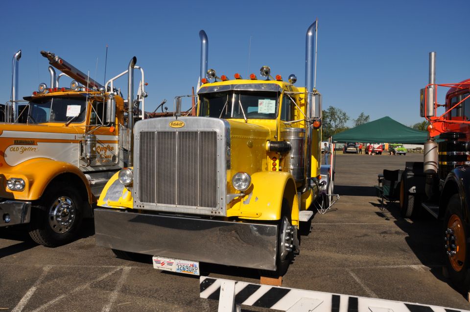 Yellow Peterbilt truck with chrome grille and stacks. License plate reads 32690RP