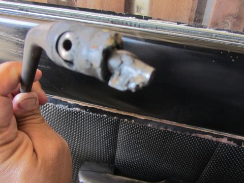 1964 Ford Ranchero - The interior door panel and window crank mechanism are visible, with the crank itself broken.
