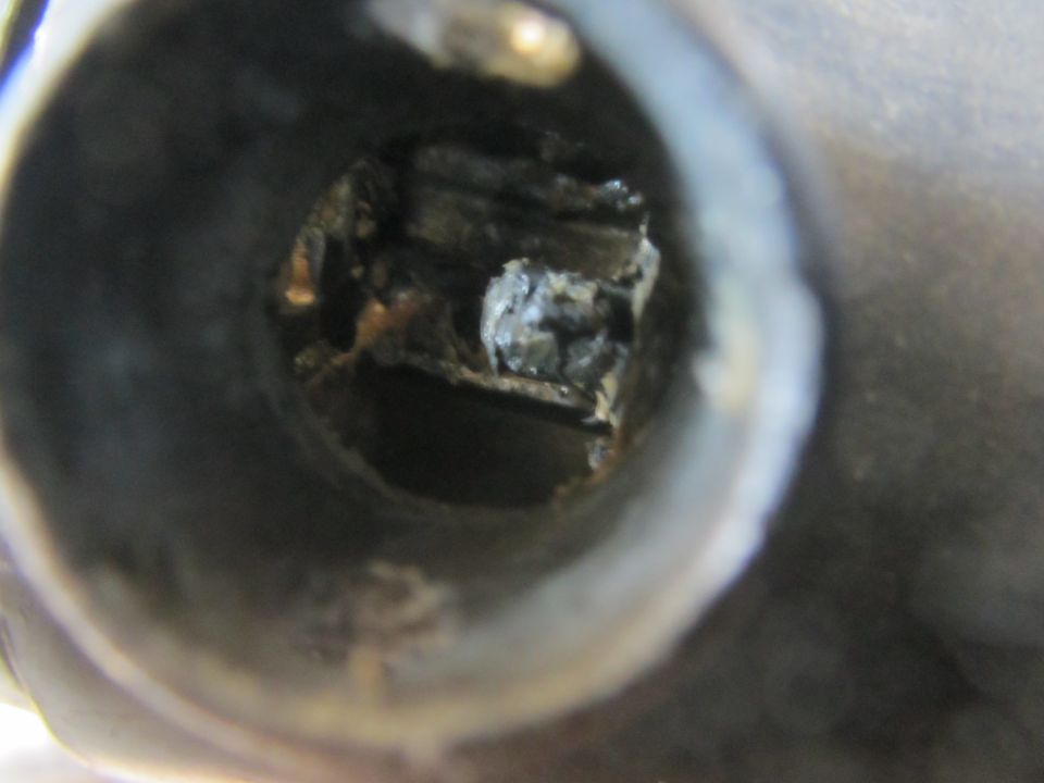 Close-up of a broken shifter mechanism with visible metal fragments