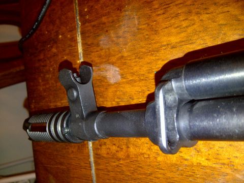 1989 Ford Bronco - Close-up view of the front sight and flash hider assembly on a firearm.