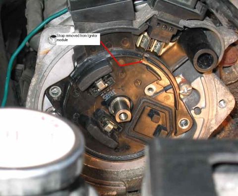 1994 Ford Probe - Close-up view of a distributor cap interior, with a label indicating a removed strap from the ignitor module.