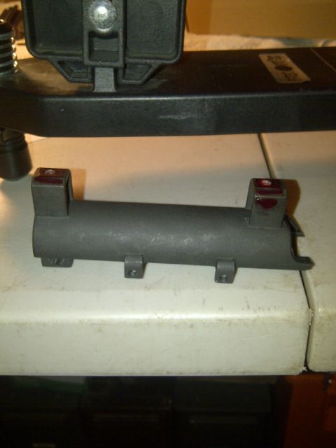 1989 Ford Bronco - A metal component with mounting points is shown, likely a vehicle part.