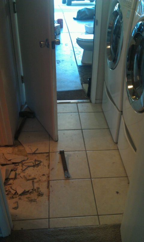 1989 Ford Bronco - Tools and debris are present in a room undergoing renovation, with laundry appliances nearby.
