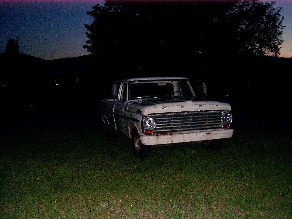 White 1967 Ford F-250 pickup truck front view at dusk