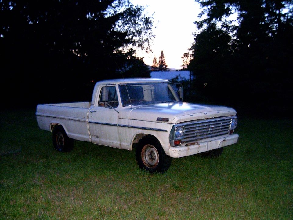 White 1967 Ford F-250 pickup truck parked on grass
