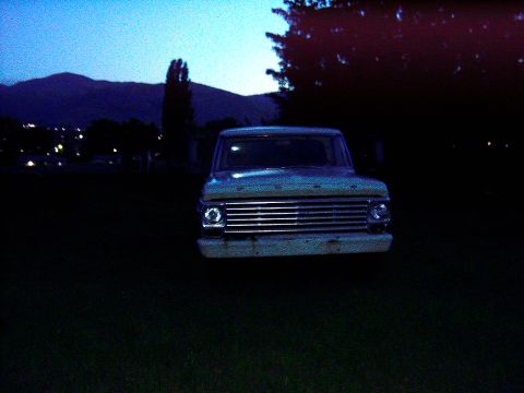 1967 Ford F-250 - Front view of a 1967 Ford F-250 parked outdoors at twilight.