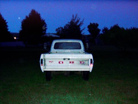 1967 Ford F-250 - 1967 Ford F-250 pickup truck seen from the rear at twilight.