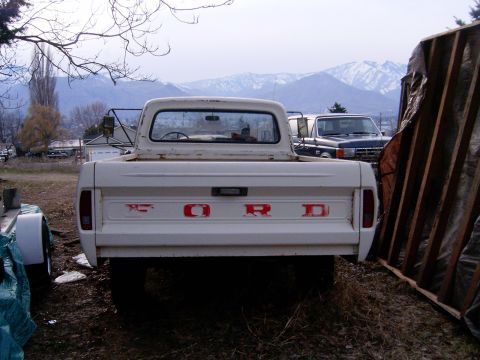 1967 Ford F-250 - A white 1967 Ford F-250 pickup truck is parked outdoors with mountains in the background.