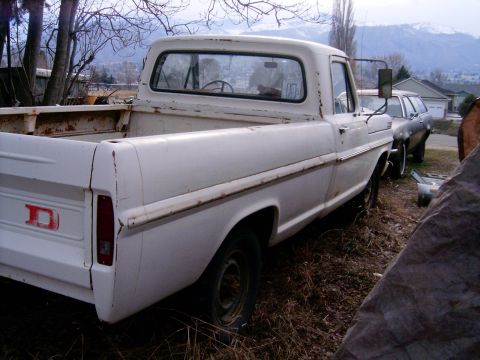 1967 Ford F-250 - Side view of a white 1967 Ford F-250 pickup truck parked outdoors with another vehicle behind it.
