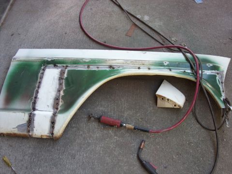 1967 Ford F-250 - A truck fender is undergoing repair with welding and grinding tools laid out.