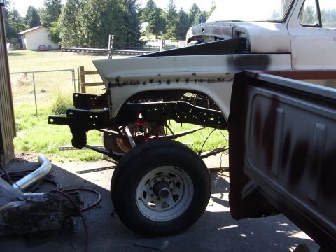 1967 Ford F-250 - A partially disassembled 1967 Ford F-250 truck is shown from the side, with its fender and bed visible.