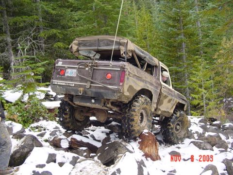 1989 Ford Bronco - This 1989 Ford Bronco navigates a challenging off-road course with snow and rocks.