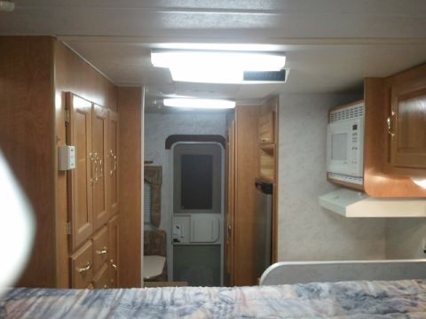 1967 Ford Mustang - This is the interior of a recreational vehicle, wood cabinetry and a microwave oven.