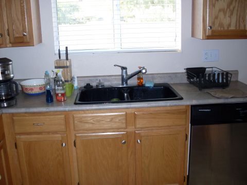 1996 Ford Bronco - A kitchen scene showing a double sink, faucet, and cabinetry.