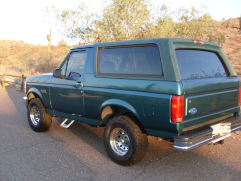 1996 Ford Bronco - This 1996 Ford Bronco is shown in a rear three-quarter view, highlighting its green paint and removable hardtop.