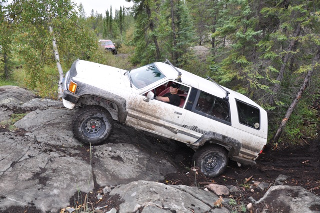 White SUV climbing rocky terrain