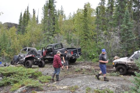 1986 Ford F-150 - Several off-road vehicles are parked in a wooded area.
