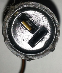 1967 Pontiac Grand Prix - This image shows a close-up of a metal engine component with visible text at the bottom.