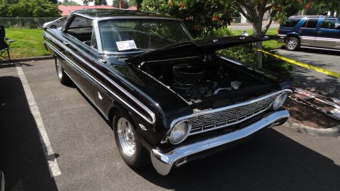 1964 Ford Fairlane - Black 1964 Ford Fairlane coupe parked outside with the hood up.