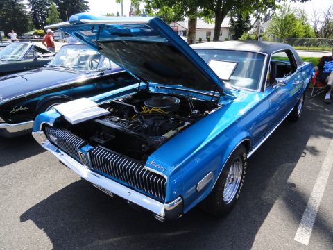 1964 Ford Fairlane - Blue 1968 Mercury Cougar XR-7 at a car show, hood and engine exposed.