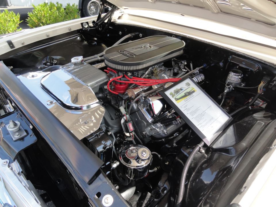 1964 Ford Fairlane engine bay with framed document