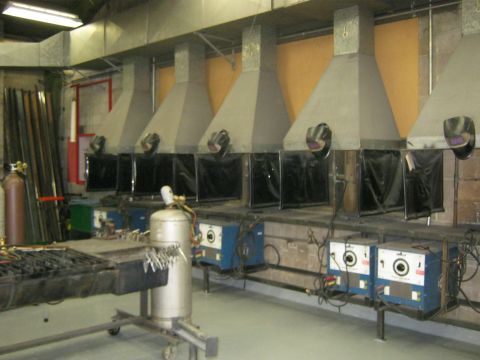 1994 Ford Bronco - A workshop scene displays multiple welding stations equipped with fume extractors and welding equipment.