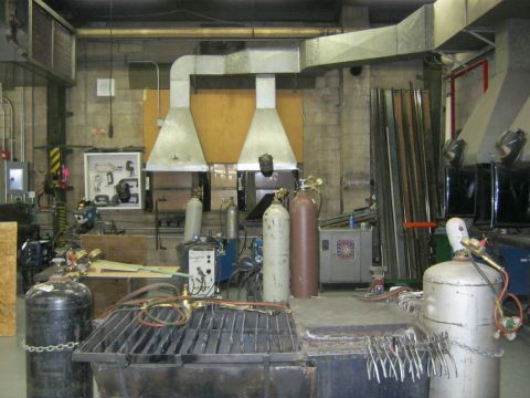 1994 Ford Bronco - Interior view of a workshop with welding equipment and gas cylinders.