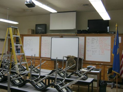 1994 Ford Bronco - A classroom scene shows chairs stacked on tables, with whiteboards and educational equipment visible.