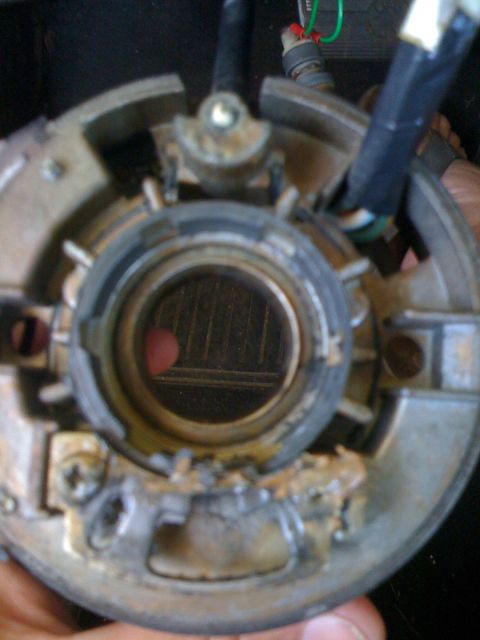1964 Ford Ranchero - Close-up view of a vehicle's steering column ignition switch housing, showing internal components and wiring.