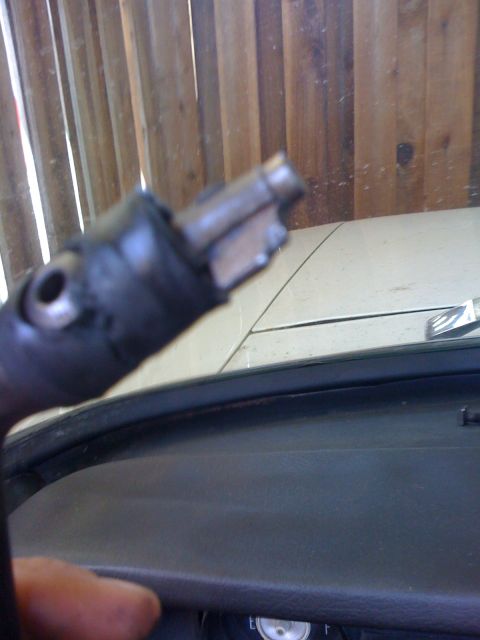 1964 Ford Ranchero - A close-up view of a broken shifter lever, with the dashboard of a vehicle in the background.