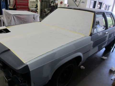 1991 Ford LTD Crown Victoria - 1991 Ford Crown Victoria LTD in a workshop, prepped for paint with hood and windshield covered.