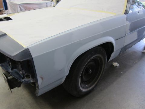 1991 Ford LTD Crown Victoria - A 1991 Ford Crown Victoria LTD is in a body shop, with primer and masking tape visible on its front end.