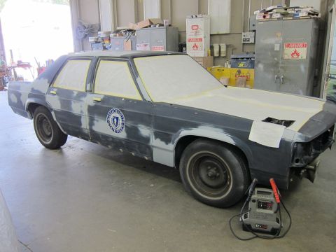 1991 Ford LTD Crown Victoria - 1991 Ford Crown Victoria LTD in primer, ready for paintwork in a workshop.