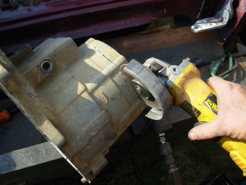 I think this will be a better (and cheaper) way to clock the t-case than buying a ring.  This is my Bronco's ORIGINAL ('83) NP208F, which grenaded a few months ago.  I'm cutting the front off through the factory-threaded mounting bolt holes so I can put sharpened bolts in backward, and use them as center pricks to mark the transmission extension.  This is the most-precise way I can think to do this, without using Ford/NP's original blueprints & CNC machinery.