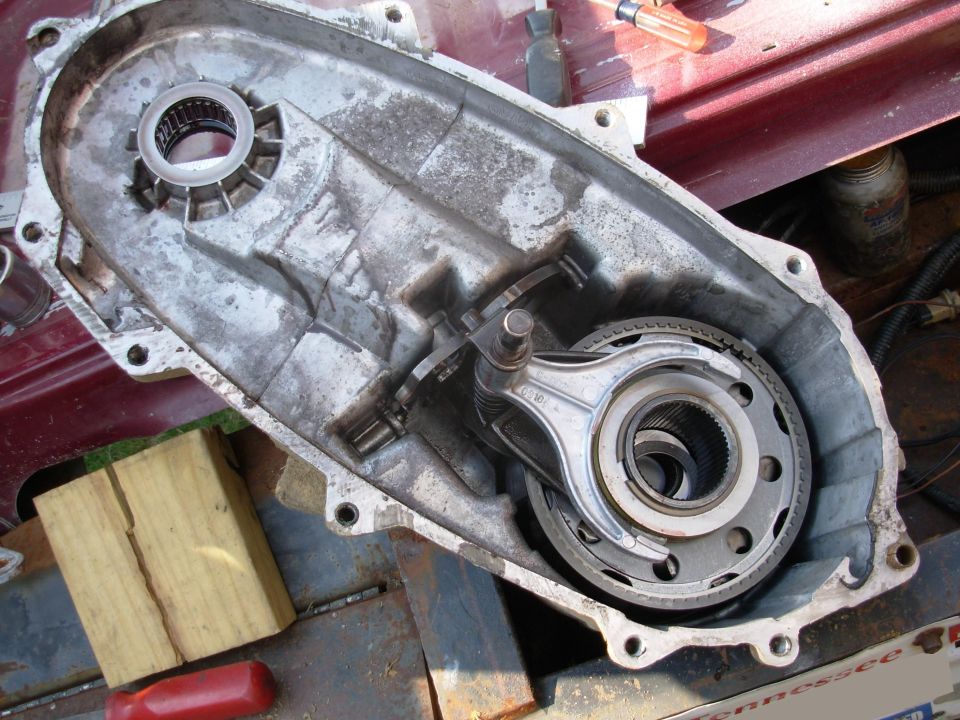 No signs of trouble here.  The range fork holds the planetary assembly in, and the shift rail & shift cam hold the fork  in.  To remove the fork, put the shift cam in any position except 4L, pull the shift rail out of the forks, and then rotate the back of the fork out of the slot in the cam.