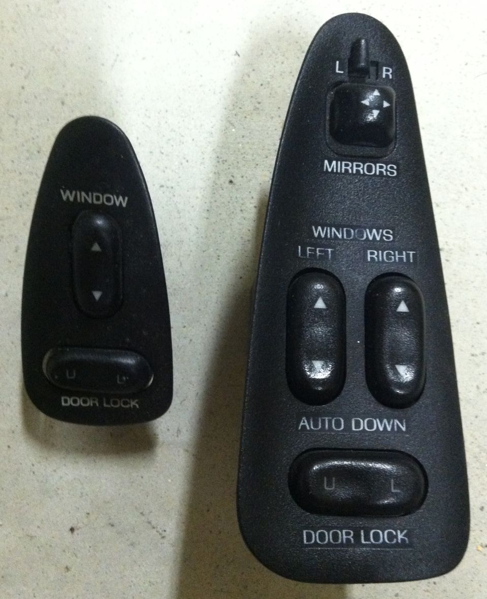 Two car door control switch assemblies, one for windows and door locks, the other for mirrors, windows, and door locks