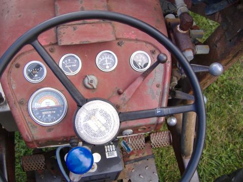 1988 Ford Bronco - Close-up of a tractor's interior, focusing on the dashboard instrumentation and steering wheel.