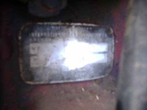 1988 Ford Bronco - A close-up shows a vehicle's identification plate with illegible markings.