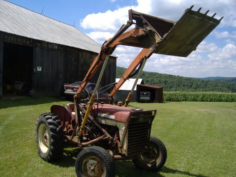 1988 Ford Bronco - Tractor with front loader in front of a barn with a cornfield in the background.