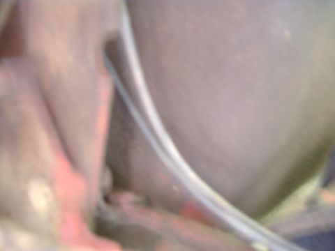 1988 Ford Bronco - A blurry interior shot shows a curved metal trim piece and red accents within the vehicle.