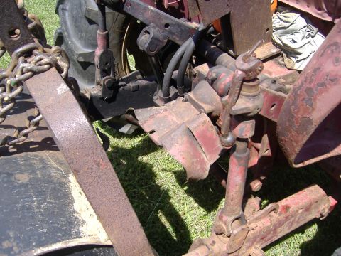 1988 Ford Bronco - Close-up view of the rear hitch assembly and hydraulic lines on a red tractor.