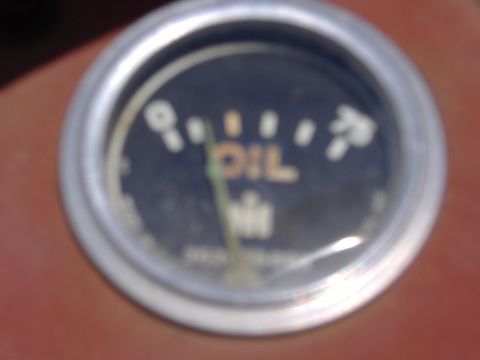 1988 Ford Bronco - Close-up of an oil pressure gauge with "IH" branding, indicating low oil pressure.