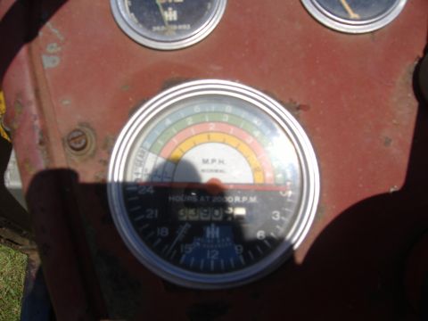 1988 Ford Bronco - Close-up of a tractor's dashboard gauges, including an hour meter and a speed indicator.