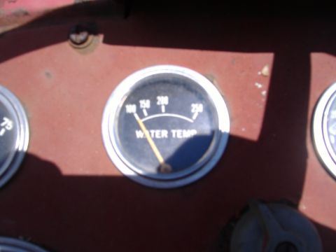 1988 Ford Bronco - A water temperature gauge shows a reading below 150 degrees on the dashboard of a vehicle.