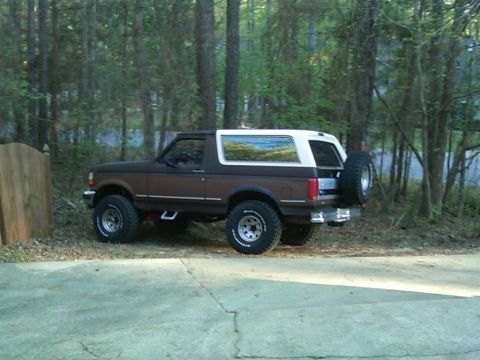 1992 Ford Bronco - This 1992 Ford Bronco is parked on a concrete driveway next to a wooden fence.